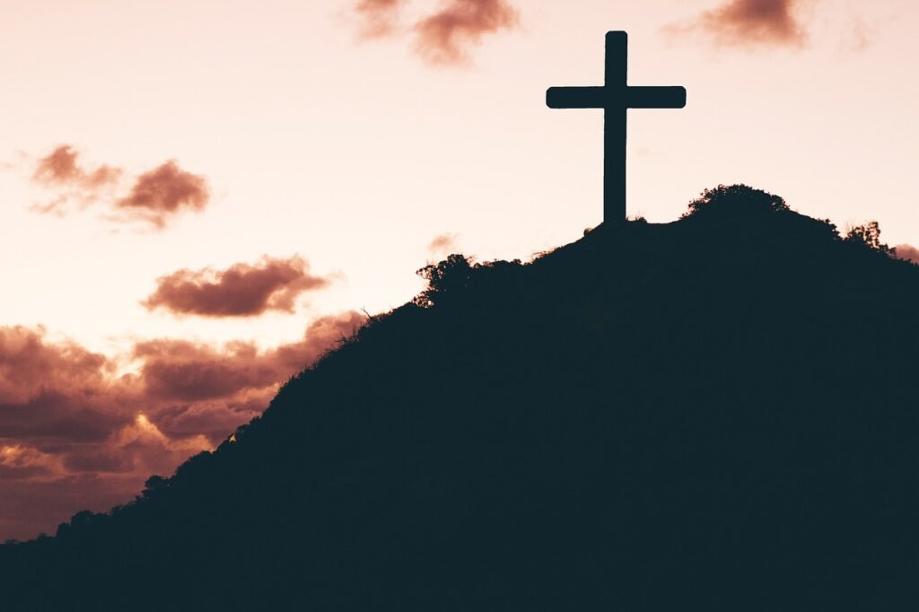 Cross on a hill, overlooking a vast landscape